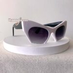 White futuristic cat eye sunglasses "Aliena" with gradient black lenses - side view